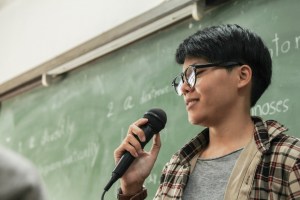 student on microphone in classroom