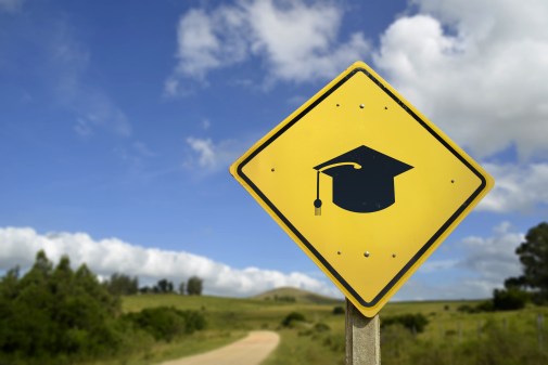 road sign with mortarboard on it