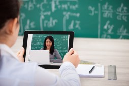 man holding tablet in classroom