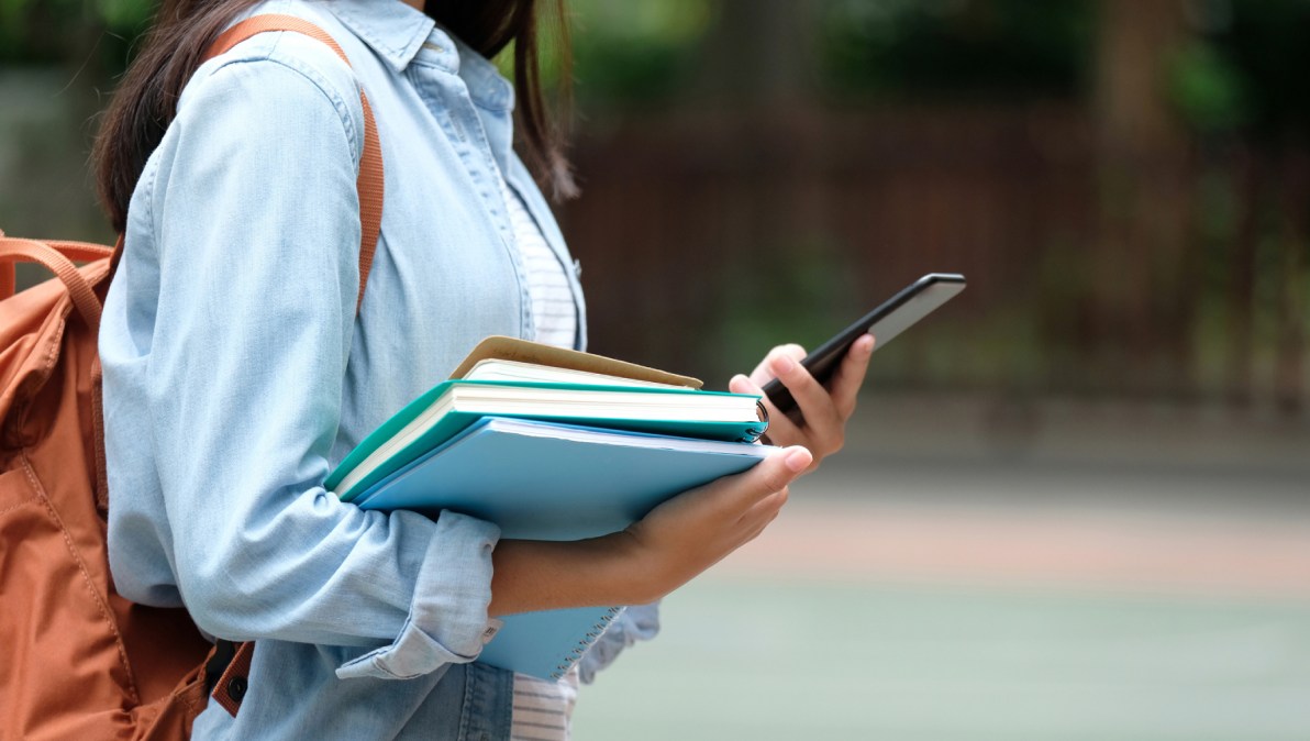 college student holding phone