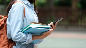 college student holding phone