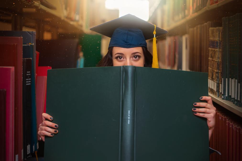 graduate holding book