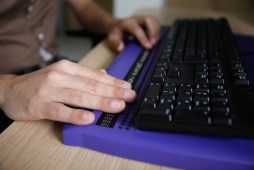 person using a keyboard for blind people