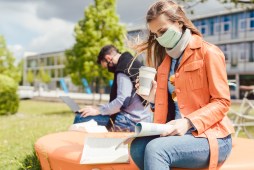 college students studying outside wearing masks