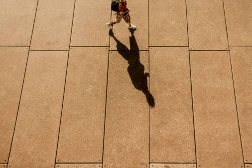 student walking shadow