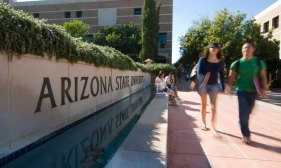 students walk by Arizona State University campus sign