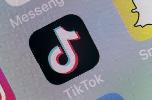 A photograph of the TikTok app logo on a mobile phone.