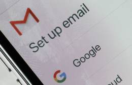 Close up photograph of a phone screen showing the Gmail envelope logo with the words "set up email" underneath, and underneath that - the Google logo.